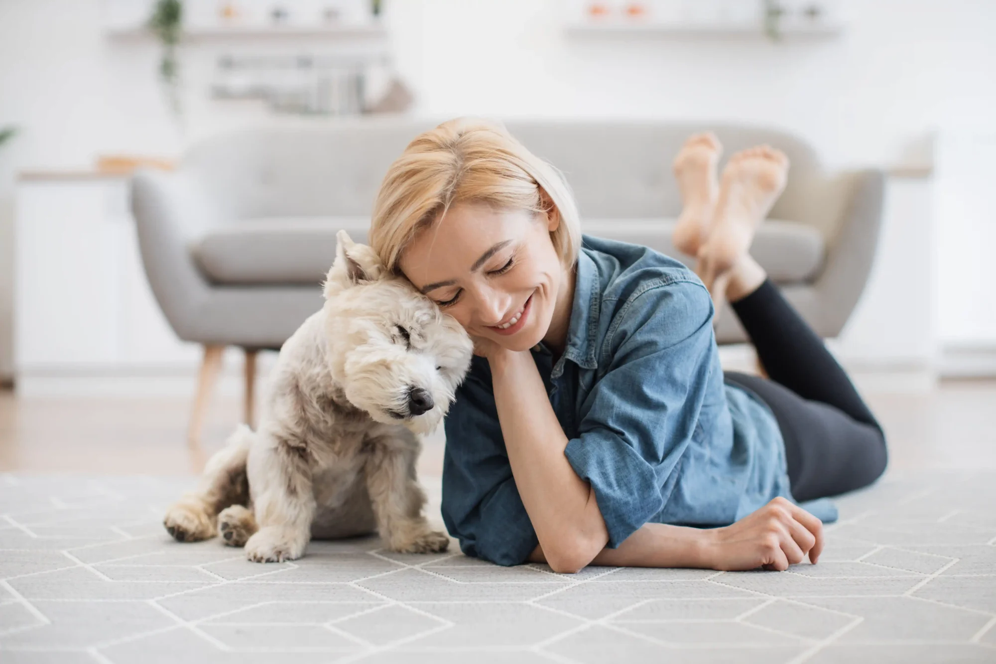 woman laying on the floor with a dog