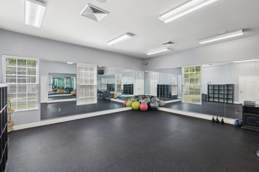 Photo of fitness center yoga room with full length mirror and yoga balls
