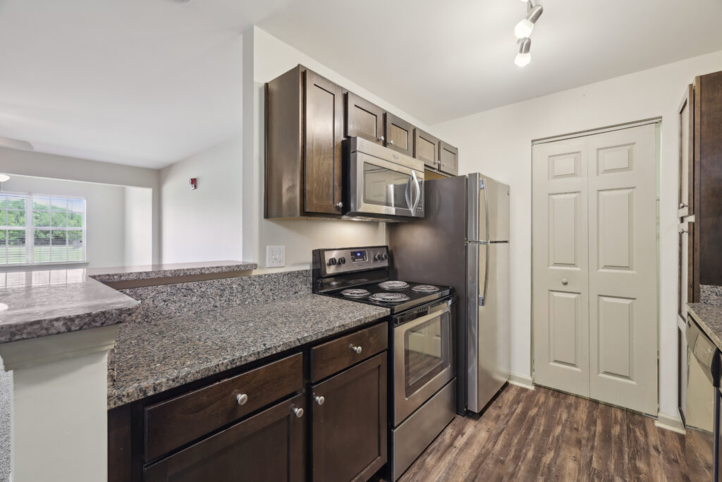 Photo of a kitchen with stove, refrigerator, and microwave